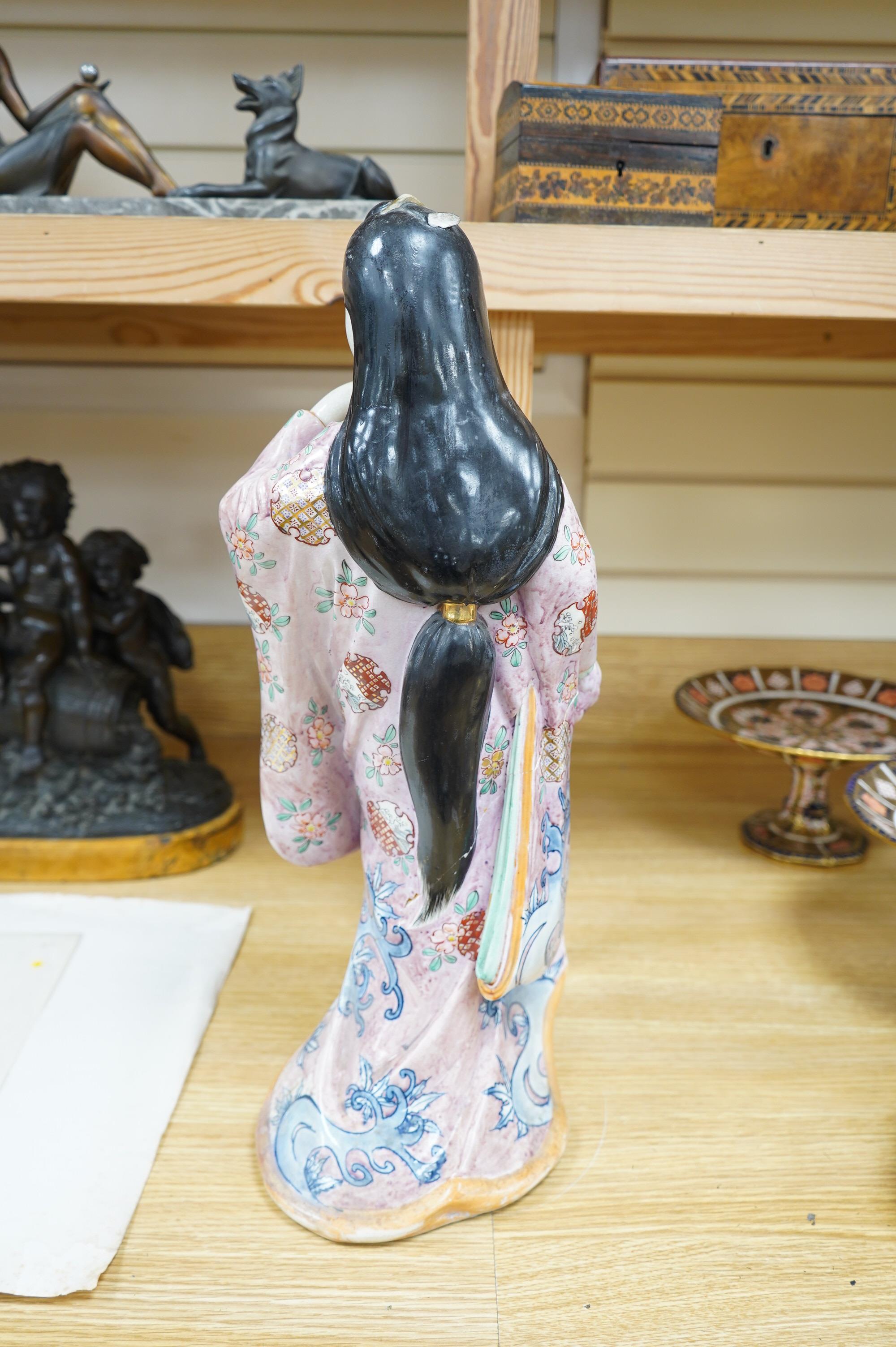 A Japanese earthenware figure of a lady, circa 1900, 46cm. Condition - poor